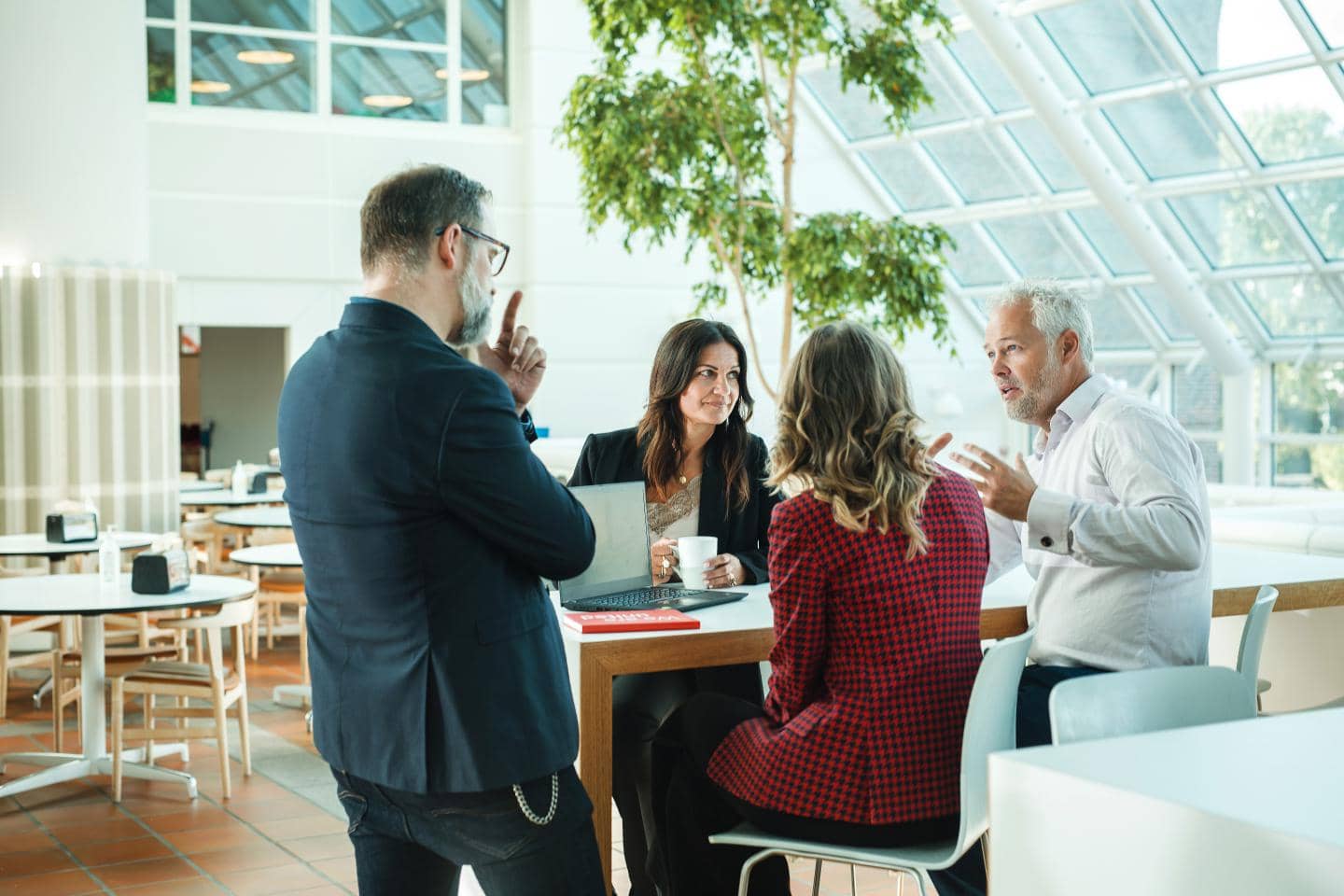 fire mennesker rundt om et bord
